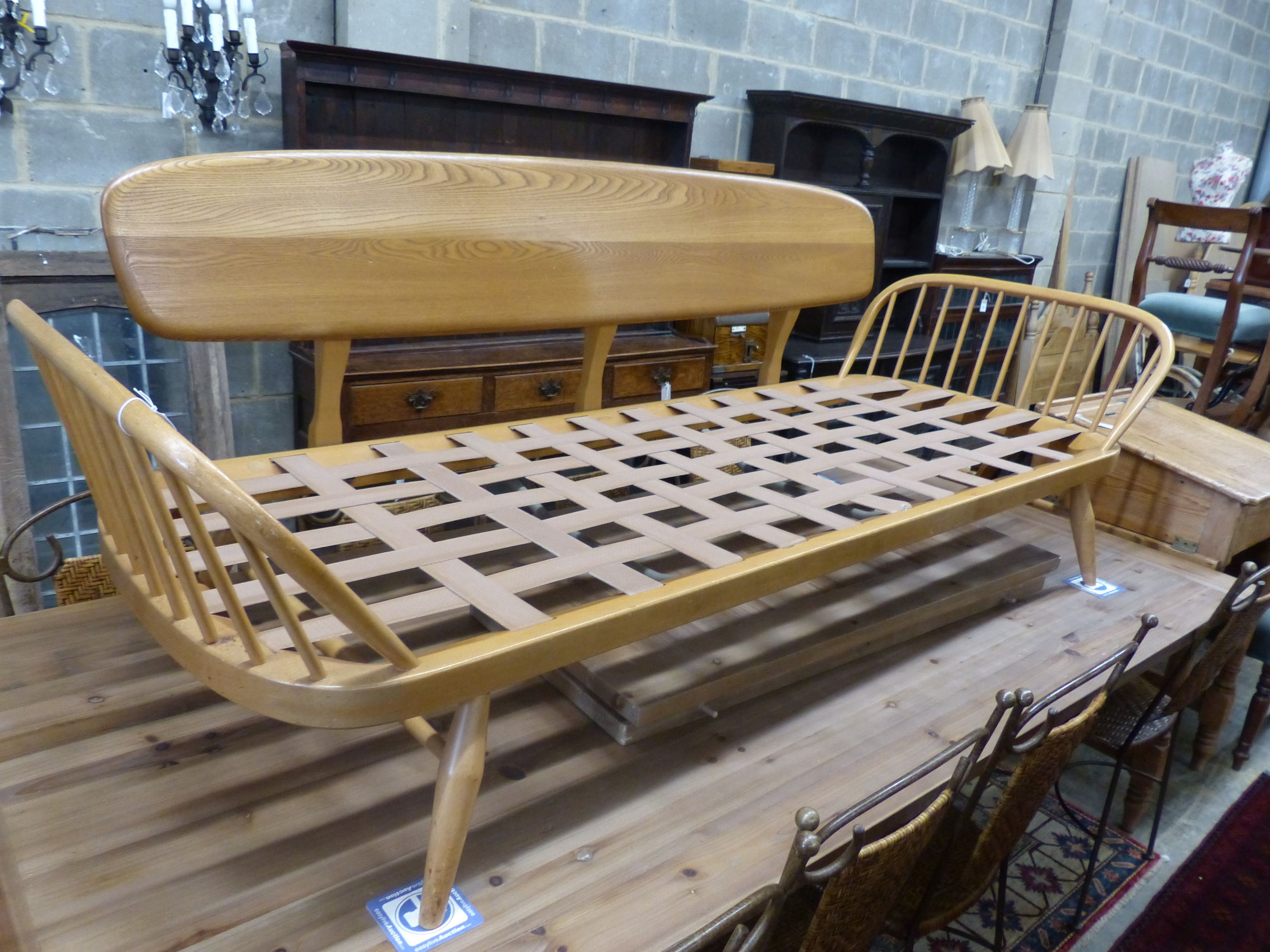 An Ercol light elm and beech settee 'surfboard' settee, length 206cm, depth 75cm, height 72cm